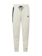 Nike Sportswear Housut 'TECH FLEECE'  pastellinvihreä / musta